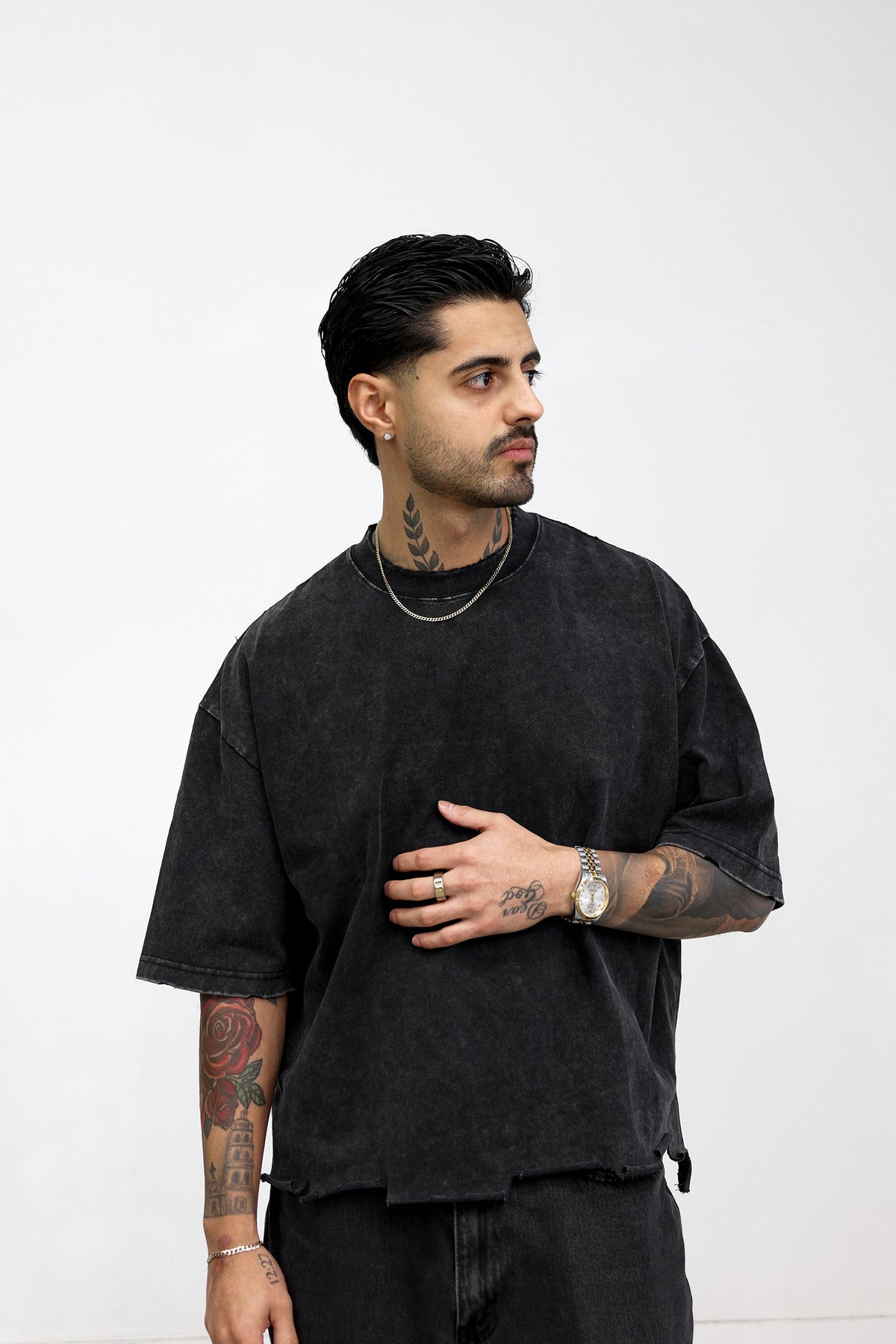 Model wearing the heavyweight raw-hem boxy tee in washed black, close-up