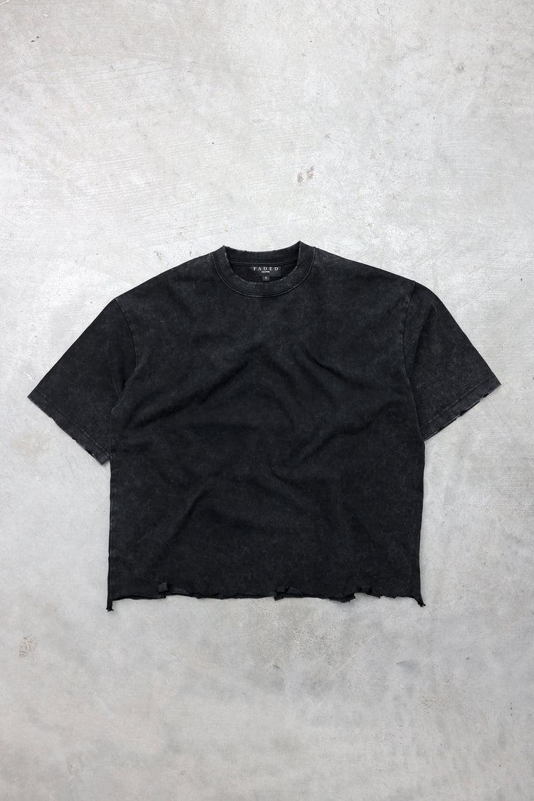 Heavyweight raw-hem boxy tee in washed black, flat lay