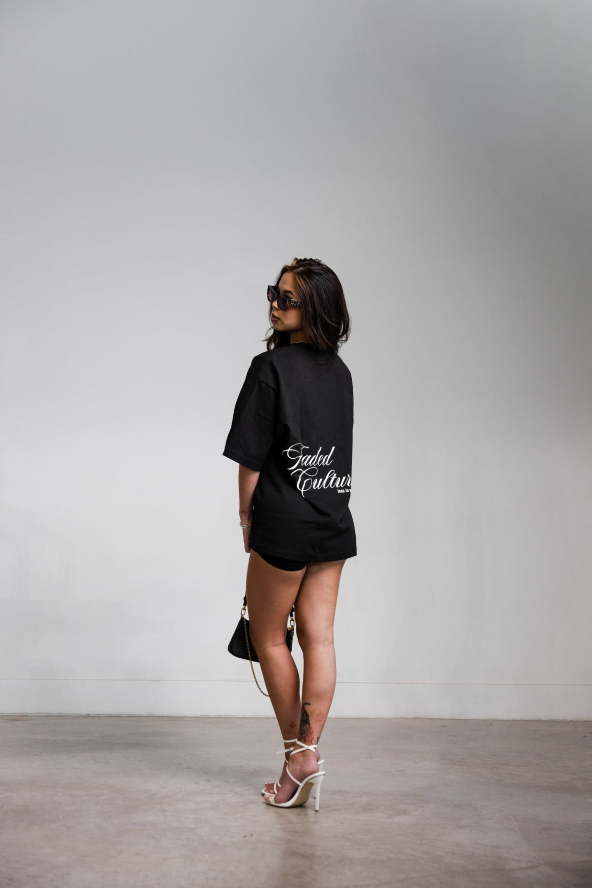 Faded Culture Less Is More tee, black — back view on model, women's fit #color_black