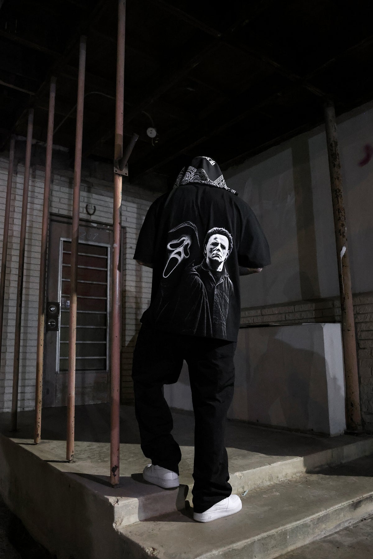 Model wearing Masked Up tee, back view, size XL